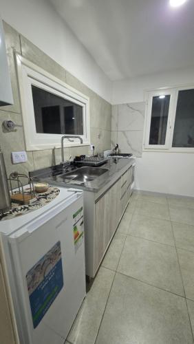a kitchen with a sink and a stove at VMV Departamento in Río Grande