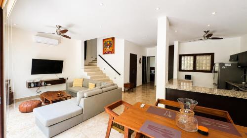 a living room with a couch and a table at Townhome with private Rooftop & Jacuzzi - Beach across street in Akumal