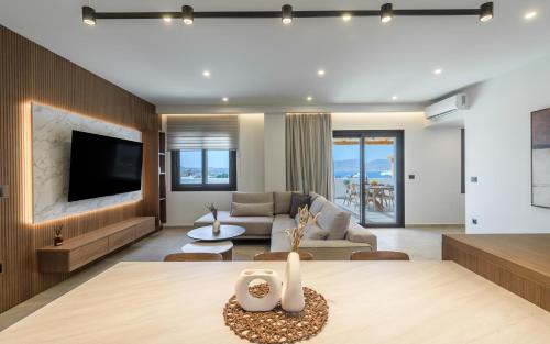a living room with a couch and a table at Serenya Hotel Milos in Adamantas