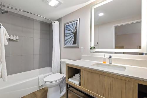 a bathroom with a sink and a toilet and a tub at Pasadena Inn at Old Town, Los Angeles in Pasadena