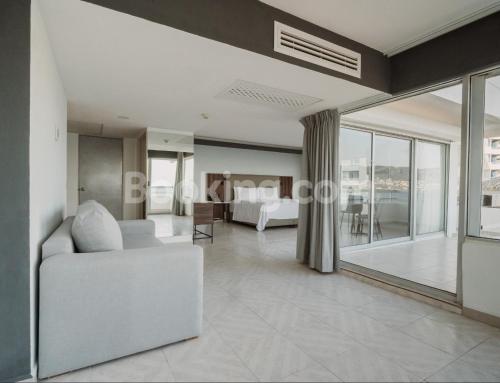 a living room with a white couch and a table at HS HOTSSON Hotel Acapulco in Acapulco