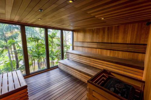 a room with a sauna with a bench and windows at Hotel La Croix in Honolulu