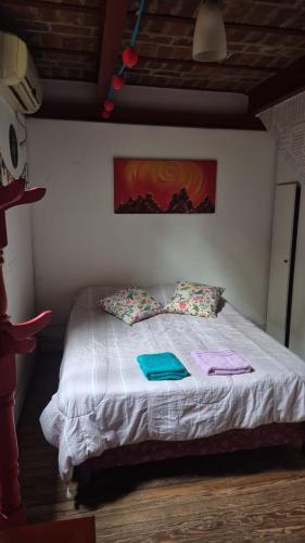 a bedroom with a bed with towels on it at Casa Pugliese in Buenos Aires