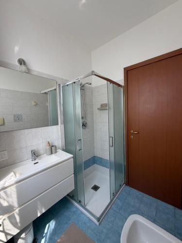 a bathroom with a shower and a sink and a toilet at Ambra House in Piacenza