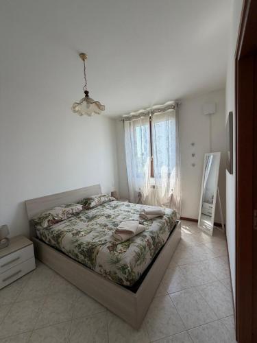 a bedroom with a bed in a room with a window at Ambra House in Piacenza