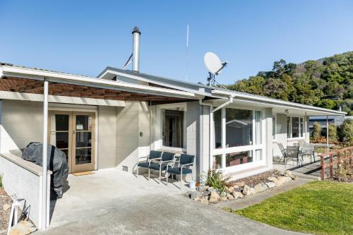 a house with a satellite on the roof at Central, Affordable, Boat Parking - KK18865 in Kaikoura