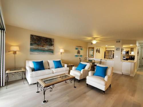 a living room with two couches and a coffee table at 1315 Pelican Watch Villas-Beachfront & Amenities - on Sale in Seabrook Island