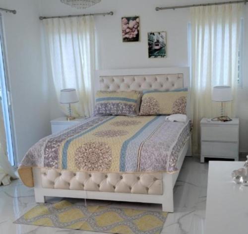 a bedroom with a large bed and two night stands at Casa Same Hotel in Atacames