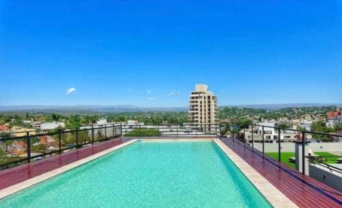 a swimming pool on the balcony of a building at Paseo Cibeles departamento in Villa Carlos Paz