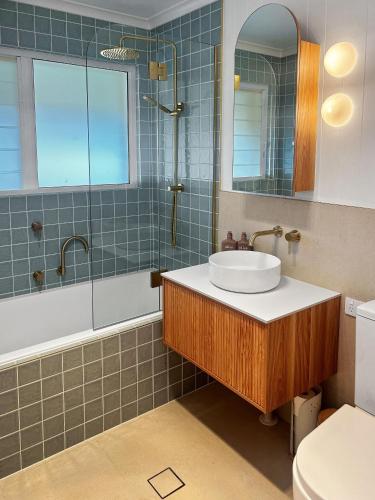 a bathroom with a sink and a shower and a toilet at 39 Scenic Drive in Bermagui
