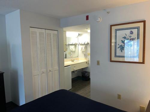 a bathroom with a sink and a mirror at Anastasia Inn - Saint Augustine in St. Augustine