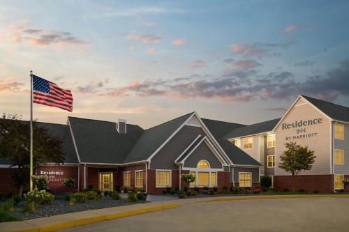 a hospital with an american flag in front of a building at Residence Inn by Marriott Flint Grand Blanc in Flint
