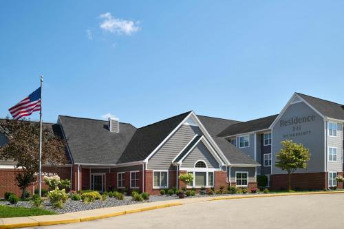 a building with an american flag in front of it at Residence Inn by Marriott Flint Grand Blanc in Flint