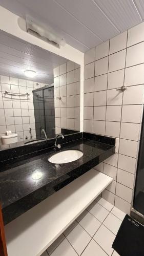 a bathroom with a sink and a mirror at 204 Eco Paradise Cumbuco in Caucaia