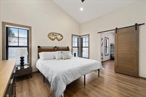 a bedroom with a large bed and a wooden door at Evergreen Retreat Red Lodge in Red Lodge