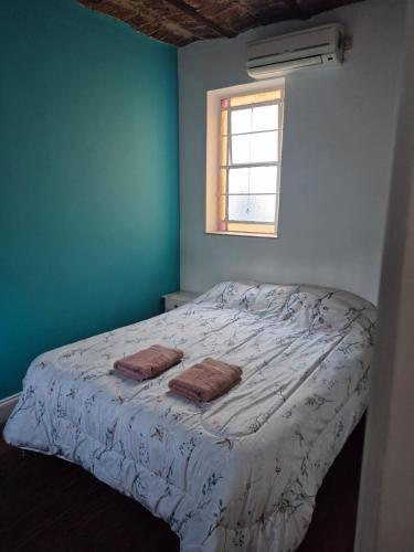 a bedroom with a bed with two towels on it at Casa Pugliese in Buenos Aires