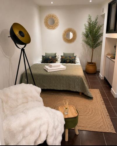 a bedroom with a bed and a lamp and a chair at Casa Maria in Bezons