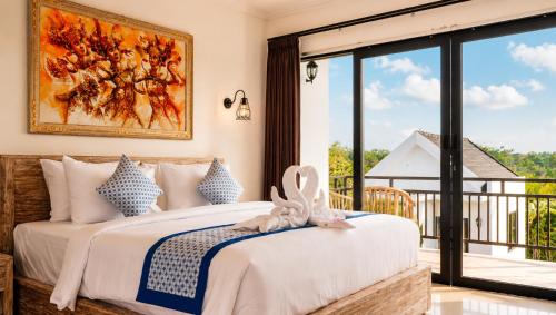 a bedroom with a bed and a large window at Penida Cabins in Nusa Penida