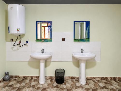 a bathroom with two sinks and two windows at Muso guesthouse in Yukary-Ukhum