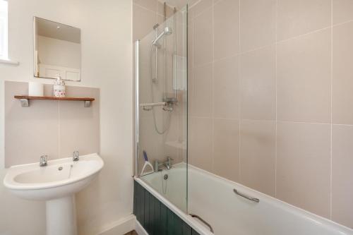 a white bathroom with a sink and a shower at 2 Bed in Warminster oc-52105 in West Knoyle