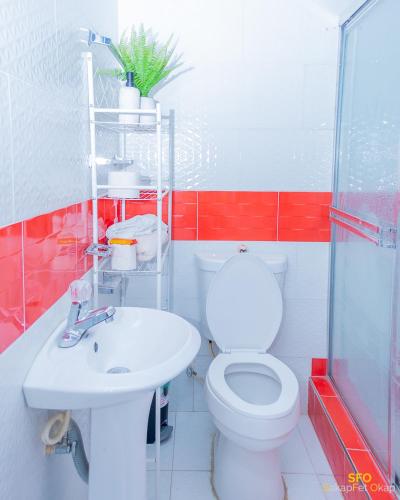 a bathroom with a toilet and a sink at La Reserve Hotel in Cap-Haïtien