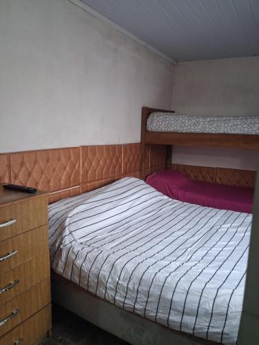 a bedroom with two bunk beds and a dresser at Apto centrico in Dolores