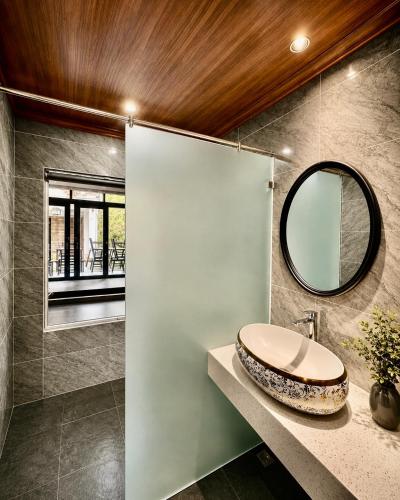 a bathroom with a sink and a mirror at Luang Prabang Indochine Heritage Hotel in Luang Prabang