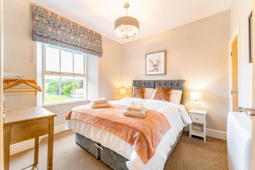 a bedroom with a bed and a window and a sink at 2 Bed in Ambleside oc-lr049 in Ambleside