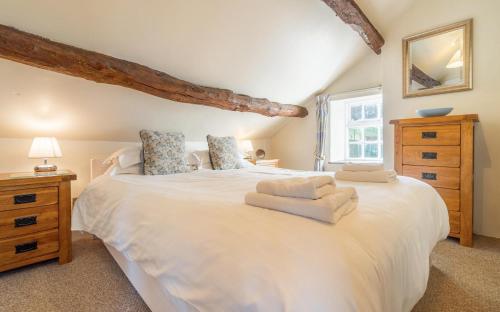 a bedroom with a large white bed and a window at 1 Bed in Hawkshead oc-lr072 in Hawkshead