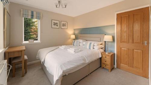 a bedroom with a large white bed and a window at 4 Bed in Ambleside oc-lr120 in Ambleside