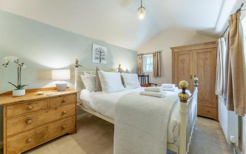 a bedroom with a white bed and a wooden dresser at 1 Bed in Grasmere oc-lr124 in Grasmere