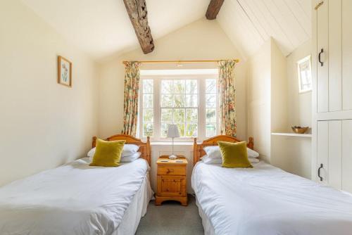 two twin beds in a room with a window at 5 Bed in Hawkshead oc-lr134 in Hawkshead