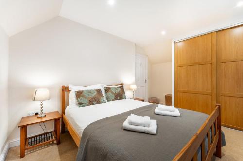 a bedroom with a large bed with two towels on it at 1 Bed in Skelwith Bridge oc-lr159 in Elterwater