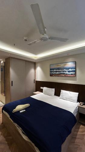 a bedroom with a large bed with a ceiling at Bee Home Stay in Greater Noida