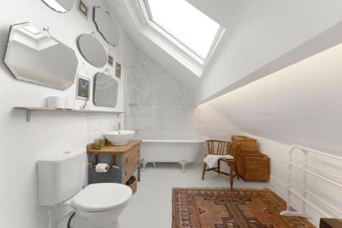 a bathroom with a toilet and a tub and a sink at 3 Bed in Coniston oc-lr198 in Coniston