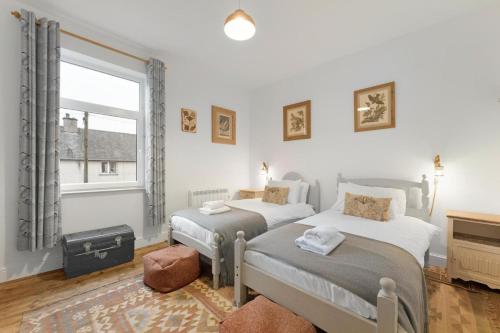 two beds in a room with a window at 3 Bed in Coniston oc-lr198 in Coniston