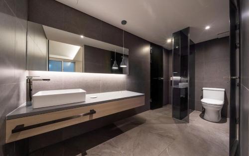 a bathroom with a sink and a toilet at H hotel Gasan in Seoul