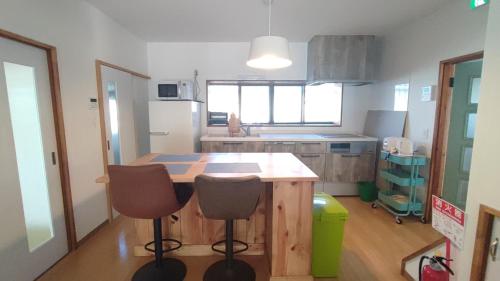 a kitchen with a wooden table and two chairs at Okawaya - Vacation STAY 49372v in Ōkawa