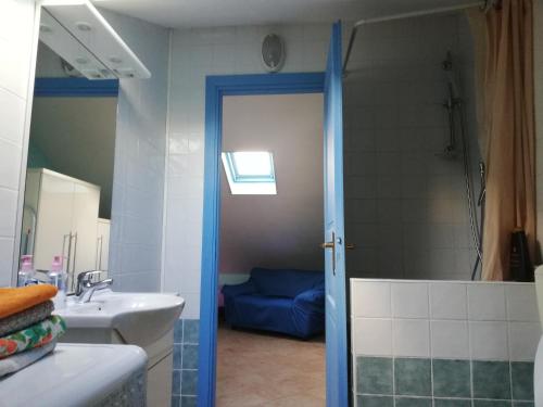a bathroom with a shower and a sink and a door at Greenhouse Torino in Turin