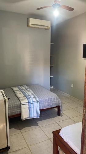 a bedroom with two beds and a ceiling fan at Hostel Solua - trindade in Paraty