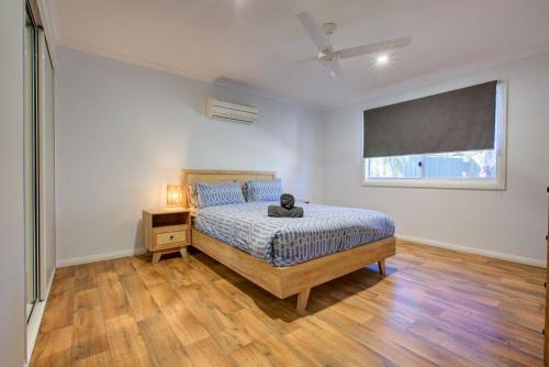 a bedroom with a bed with a cat sitting on it at Billfish in Exmouth