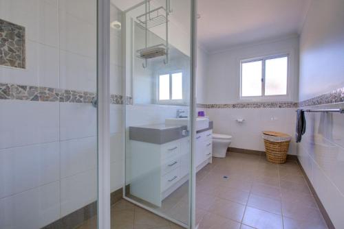 a bathroom with a shower and a sink at Billfish in Exmouth