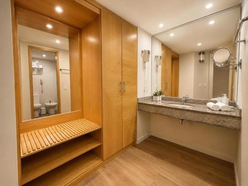 a bathroom with a sink and a mirror at Sol Alphaville Hotel By Your Alpha Stay 1602 in Barueri