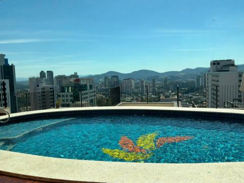 a large swimming pool on top of a building at Sol Alphaville Hotel By Your Alpha Stay 1602 in Barueri