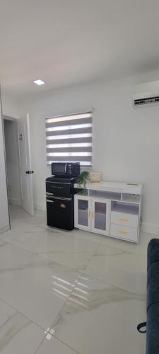 a kitchen with a black stove in a white room at Hard Rock Area Modern Studio in Miami Gardens