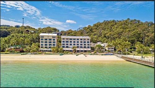 a hotel on the beach next to the water at Moreton Island Villas and Apartments in Tangalooma