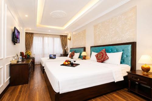 a hotel room with two beds in a room at Golden Sail Hotel & Travel in Hanoi
