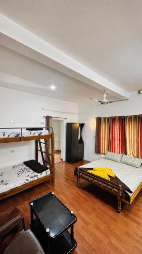 a bedroom with two bunk beds in a room at Sahyadri Homestay wayanad in Kalpetta