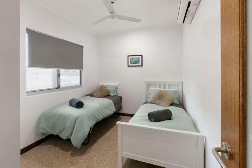 a bedroom with two beds and a window at Kingfisher in Exmouth