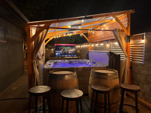 a bar with a tub and stools in a room at Zion Base 3BR Home Backyard Oasis Pets Welcome in St. George